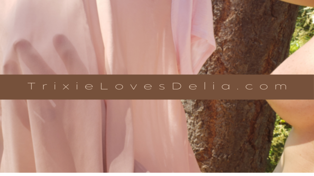 Delia's hand seen through backlit sheer mesh pink fabric